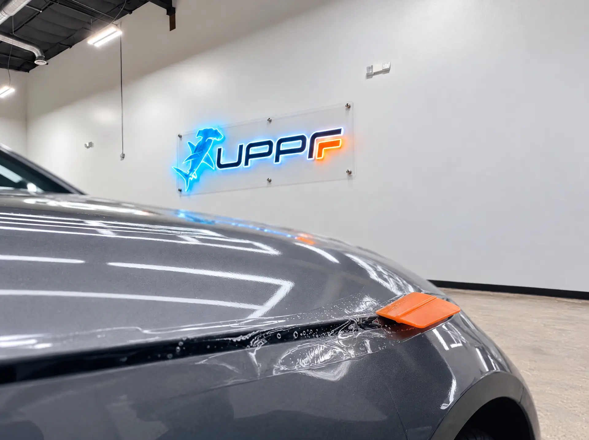Certified technician installing clear paint protection film