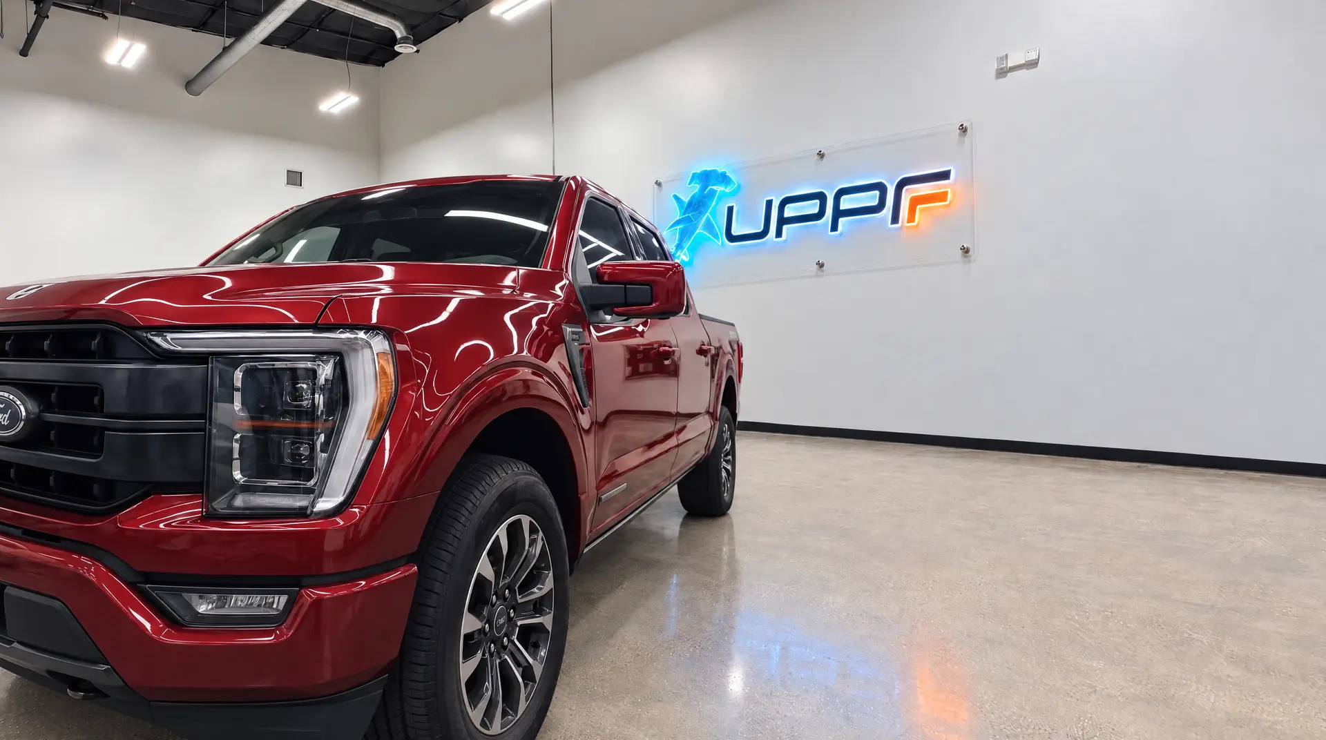 Certified technician installing paint protection film in a climate-controlled bay