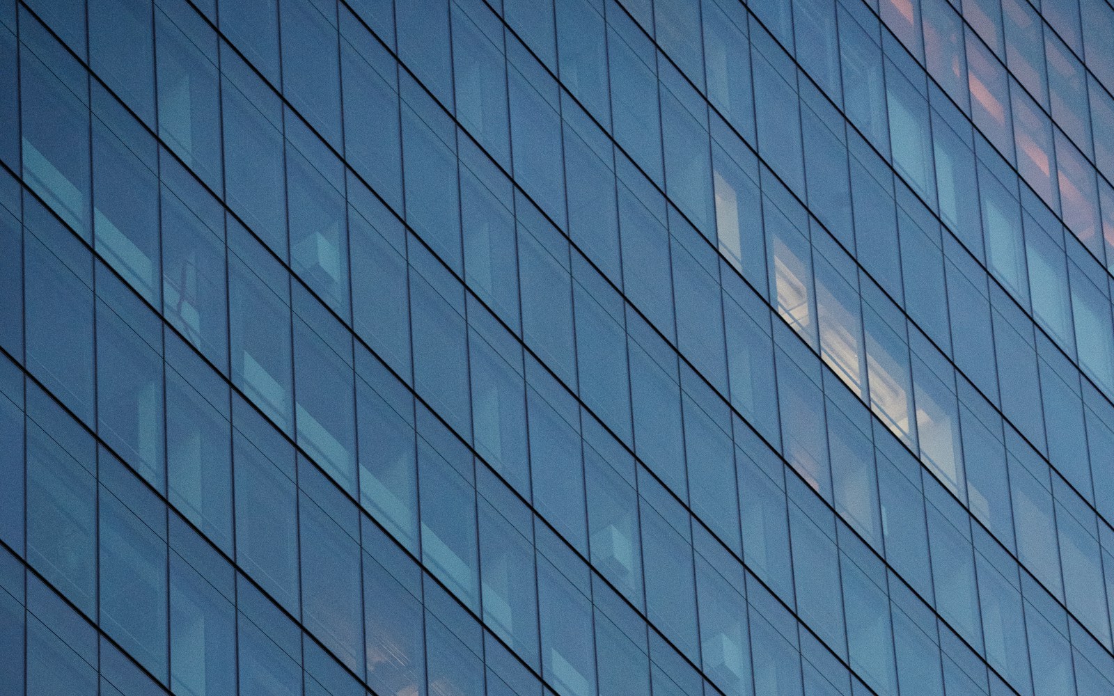 Tinted glass facade of a Houston commercial building with architectural window film